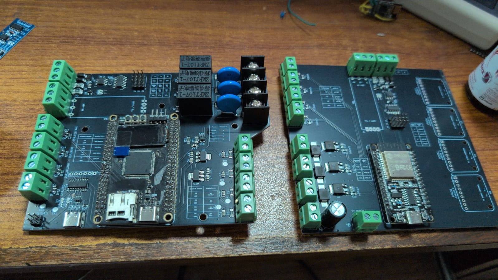Two ThermoVolt control circuit boards with green terminal blocks on a workbench